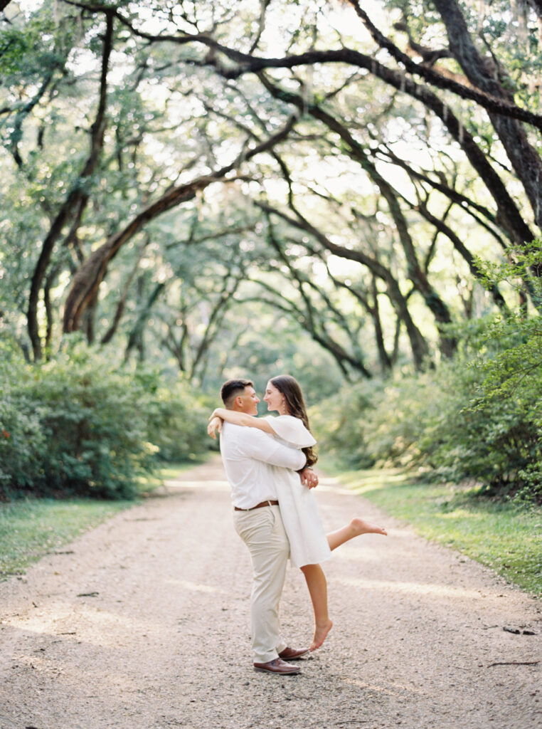 A couple in front of trees at their Afton Villa Gardens engagement session