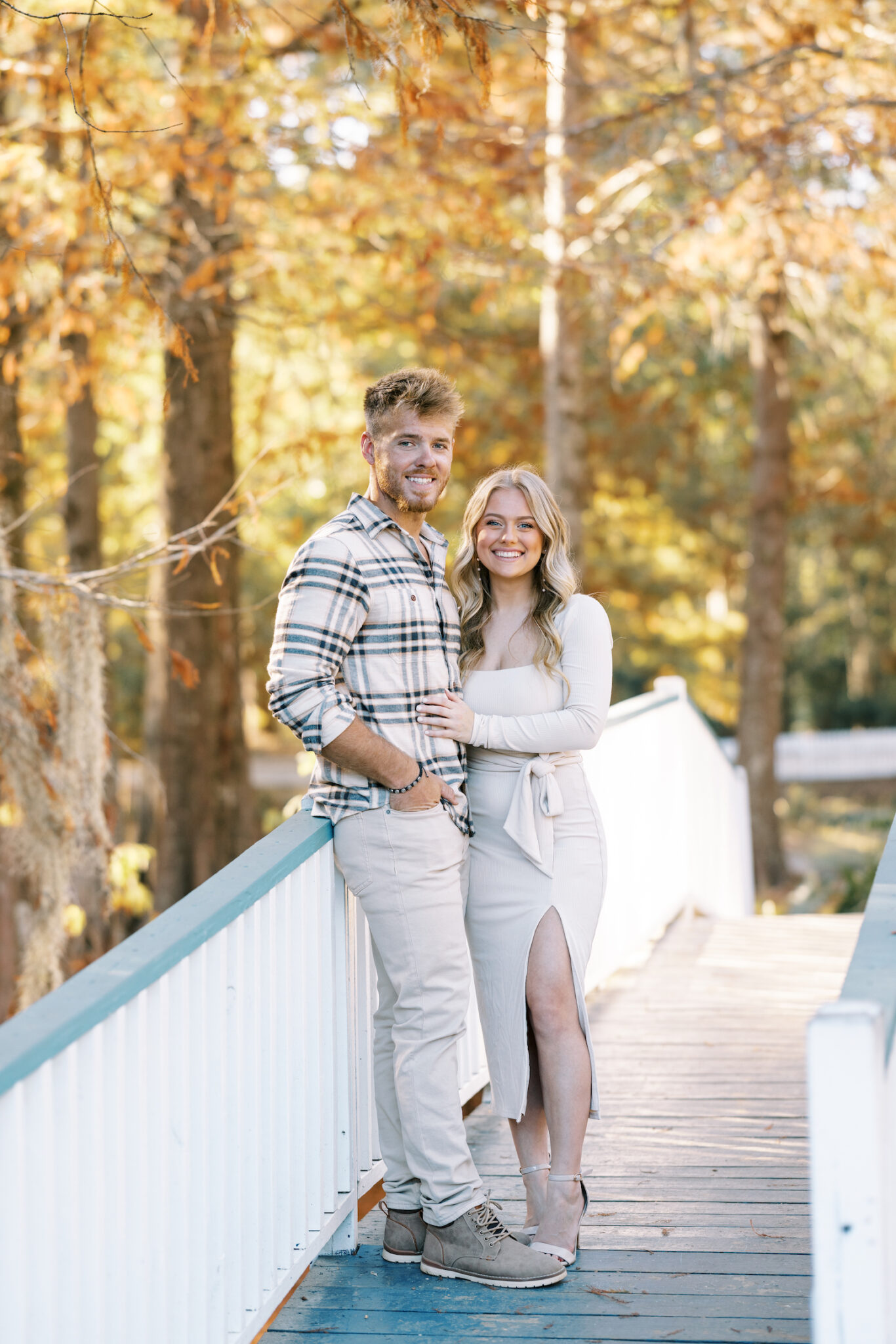 A couple dressed in neutral tones pose for fall engagement portraits at The Myrtles Plantation in Saint Francisville, LA, shot by Morgan Alysse Photography