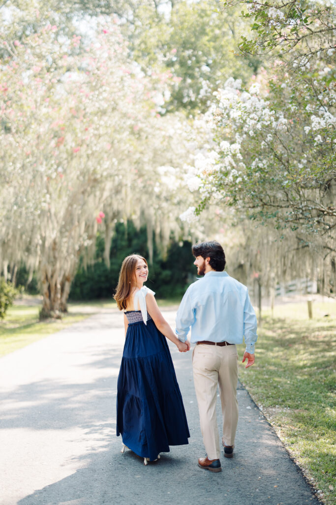 Engagement portrait in the oak-lined alley at Rosedown Plantation in Saint Francisville, LA, photographed by Morgan Alysse Photography.