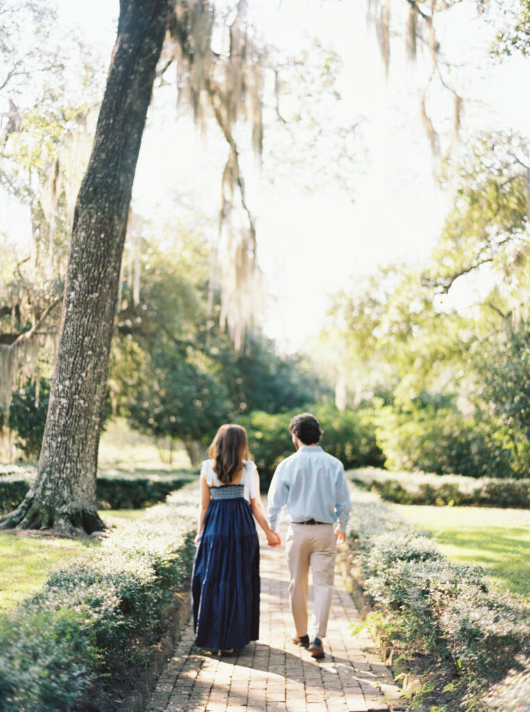 Engagement portrait in the oak-lined alley at Rosedown Plantation in Saint Francisville, LA, photographed by Morgan Alysse Photography.