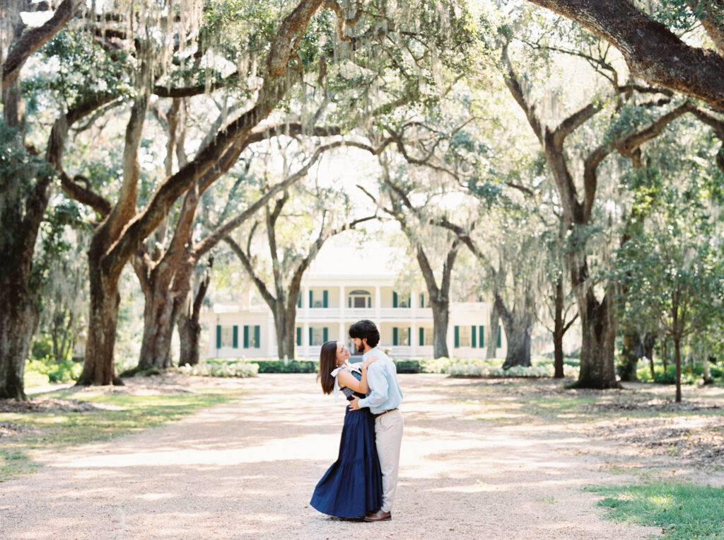 Engagement portrait in the oak-lined alley at Rosedown Plantation in Saint Francisville, LA, photographed by Morgan Alysse Photography.