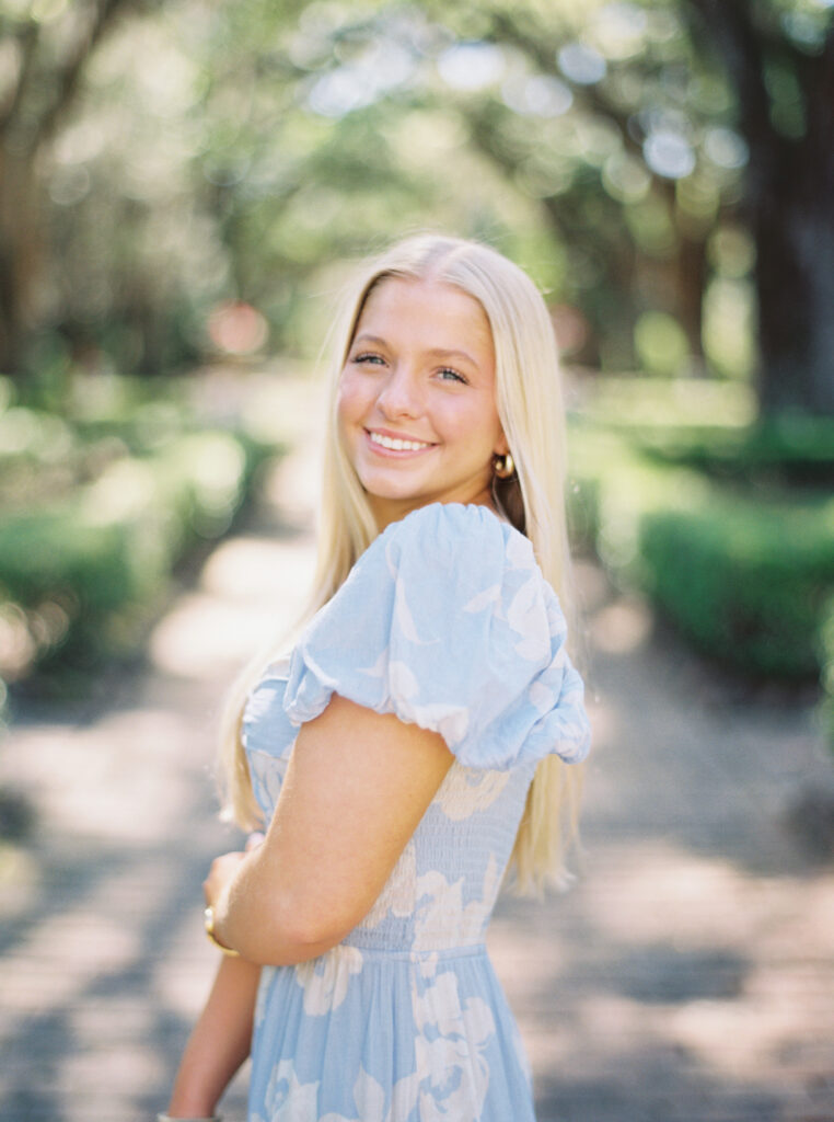 Amy standing in the oak lined alley way at Rosedown Plantation during her senior session at Rosedown Plantation, photographed by Morgan Alysse Photography