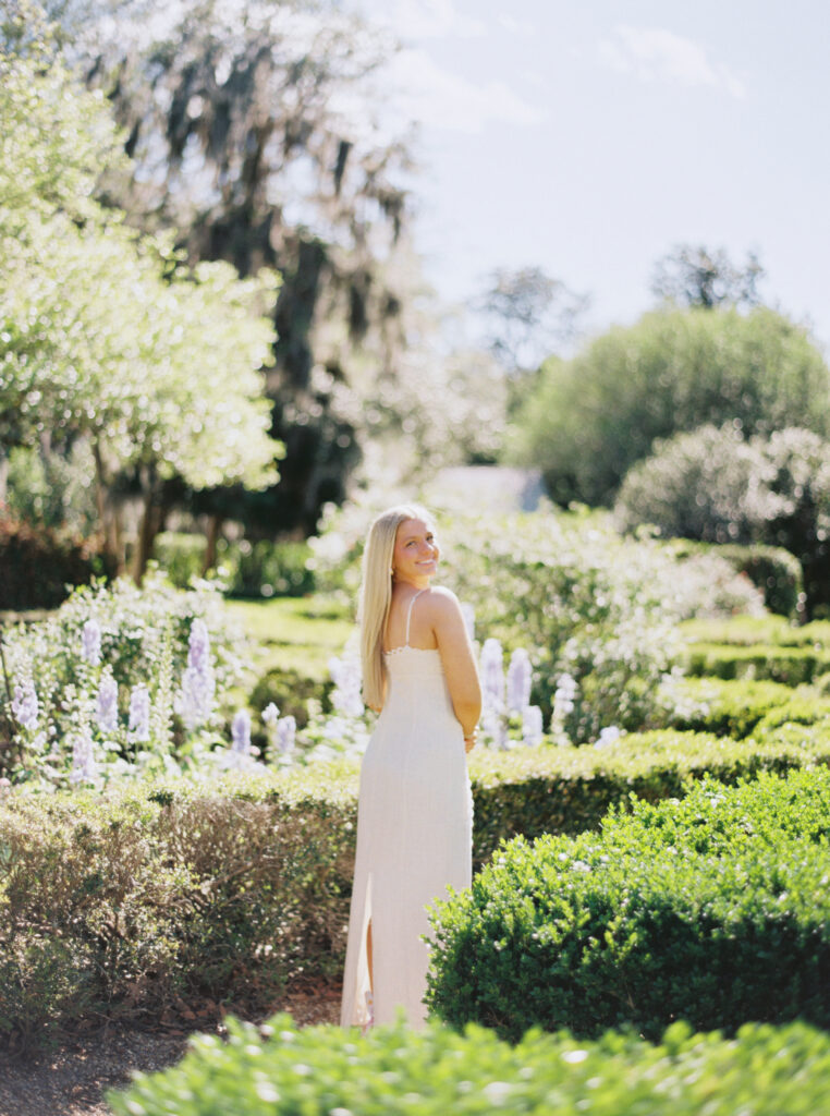 Amy standing in the blooming gardens at Rosedown Plantation during her senior session at Rosedown Plantation, photographed by Morgan Alysse Photography