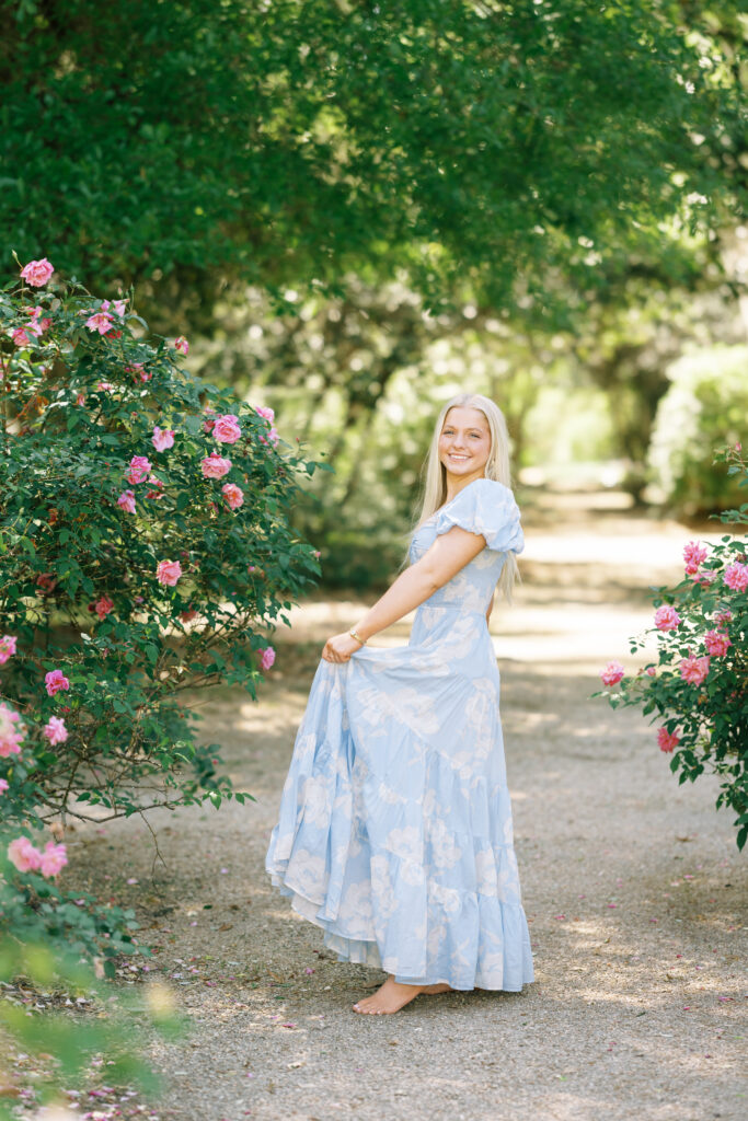 Amy standing in front of the blooming rose gardens at Rosedown Plantation during her senior session at Rosedown Plantation, photographed by Morgan Alysse Photography