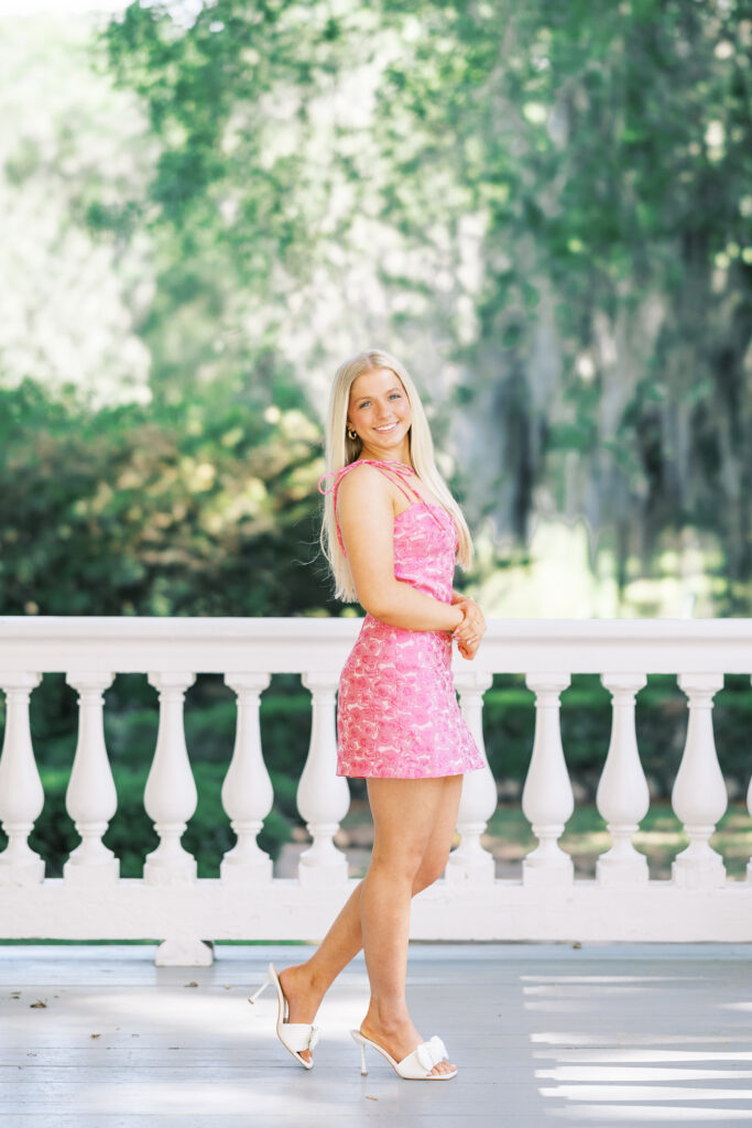 Amy standing on the charming front porch at Rosedown Plantation during her senior session at Rosedown Plantation, photographed by Morgan Alysse Photography