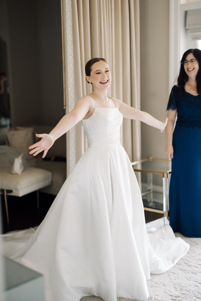 Candid portrait of bridesmaids reveal in the bridal suite at Olivia and Landon's Oak Crossing Wedding in Lake Charles, LA, photographed by Morgan Alysse Photography.