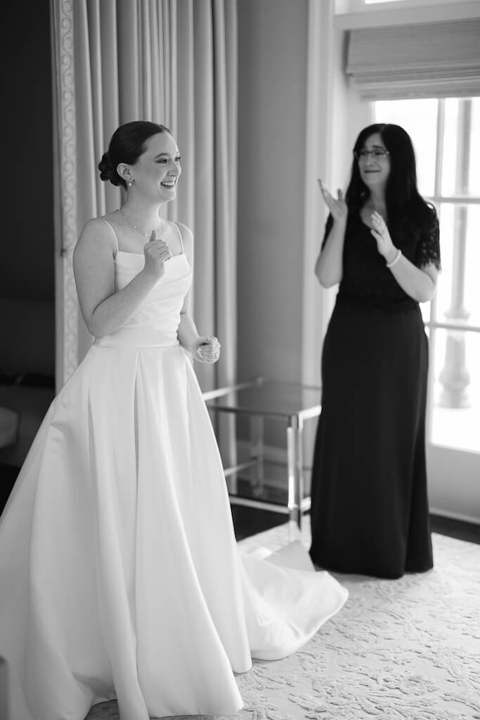 Candid portrait of bridesmaids reveal in the bridal suite at Olivia and Landon's Oak Crossing Wedding in Lake Charles, LA, photographed by Morgan Alysse Photography.