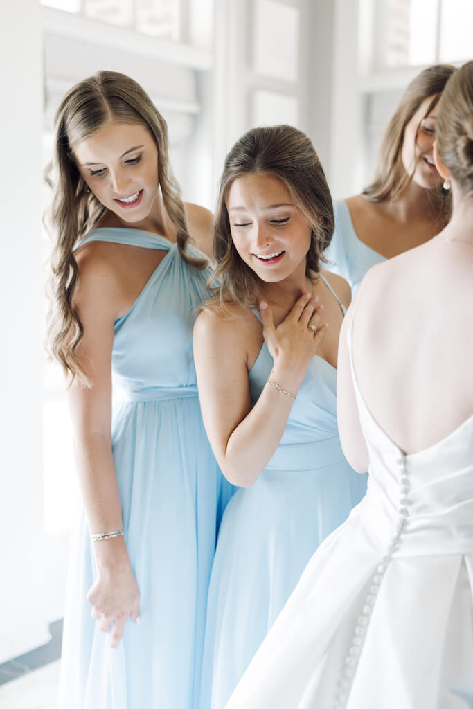 Candid portrait of bridesmaids reveal in the bridal suite at Olivia and Landon's Oak Crossing Wedding in Lake Charles, LA, photographed by Morgan Alysse Photography.