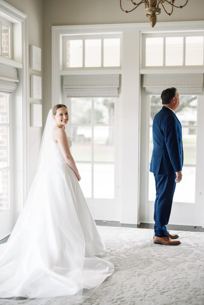 Father and daughter first look at Olivia and Landon's Oak Crossing Wedding in Lake Charles, LA, photographed by Morgan Alysse Photography.