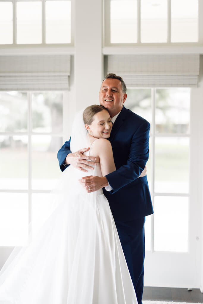 Father and daughter first look at Olivia and Landon's Oak Crossing Wedding in Lake Charles, LA, photographed by Morgan Alysse Photography.