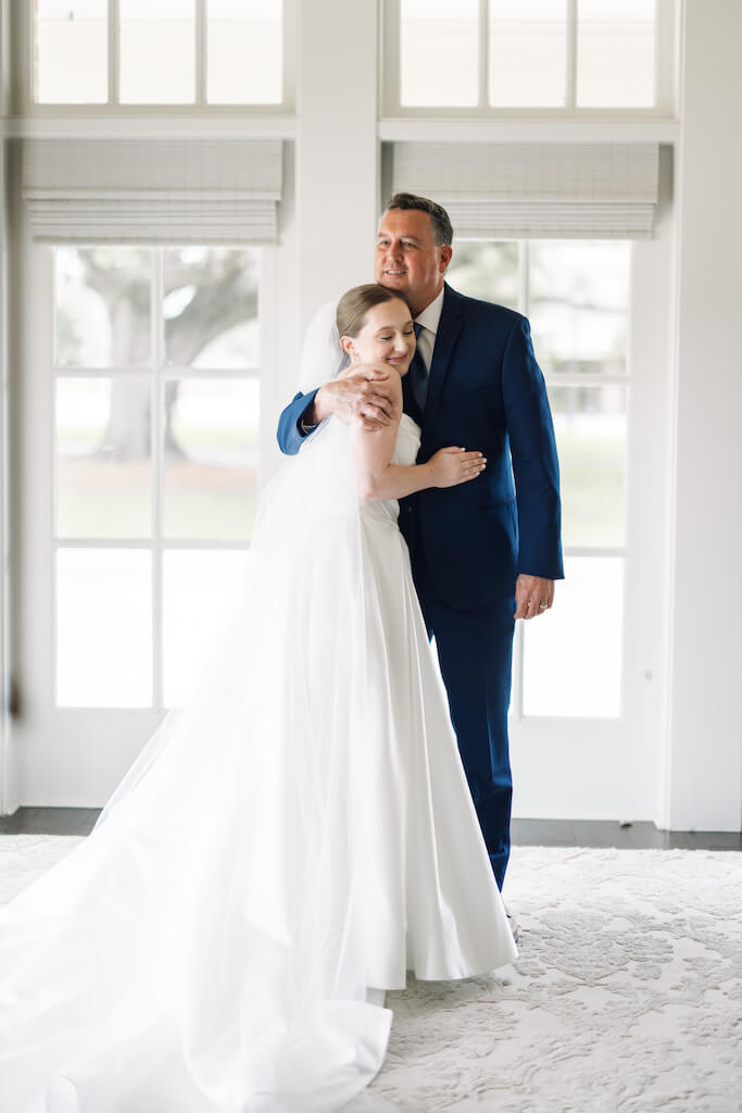 Father and daughter first look at Olivia and Landon's Oak Crossing Wedding in Lake Charles, LA, photographed by Morgan Alysse Photography.