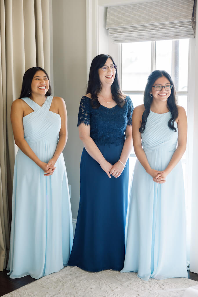 Mom and sisters watching Father and daughter first look at Olivia and Landon's Oak Crossing Wedding in Lake Charles, LA, photographed by Morgan Alysse Photography.