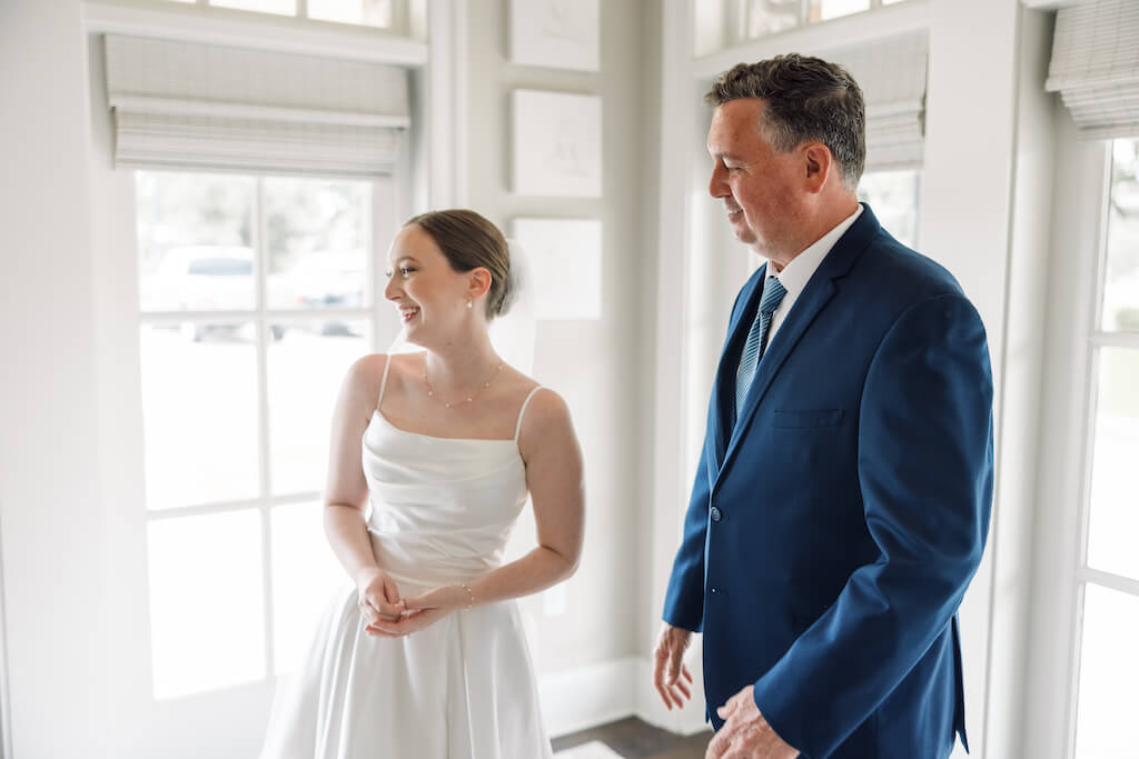 Father and daughter first look at Olivia and Landon's Oak Crossing Wedding in Lake Charles, LA, photographed by Morgan Alysse Photography.