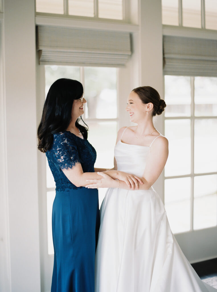 Bride getting ready with her mom  in the bridal suite at Olivia and Landon's Oak Crossing Wedding in Lake Charles, LA, photographed by Morgan Alysse Photography.