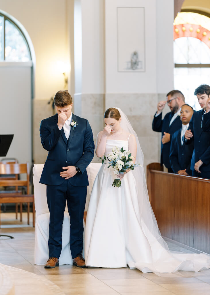 Bride and groom during their ceremony at St. Martin De Porres Catholic Church in Lake Charles, Louisiana, on Olivia and Landons Oak Crossing Wedding Day, photographed by Morgan Alysse Photography.