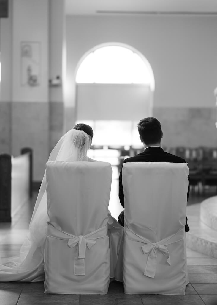 Bride and groom during their ceremony at St. Martin De Porres Catholic Church in Lake Charles, Louisiana, on Olivia and Landons Oak Crossing Wedding Day, photographed by Morgan Alysse Photography.