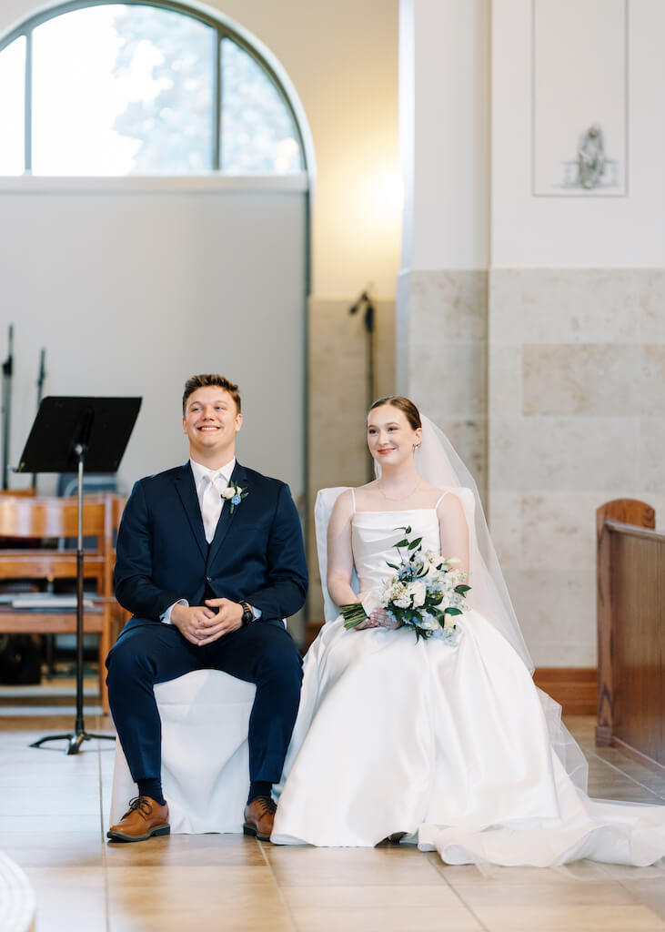 Bride and groom during their ceremony at St. Martin De Porres Catholic Church in Lake Charles, Louisiana, on Olivia and Landons Oak Crossing Wedding Day, photographed by Morgan Alysse Photography.