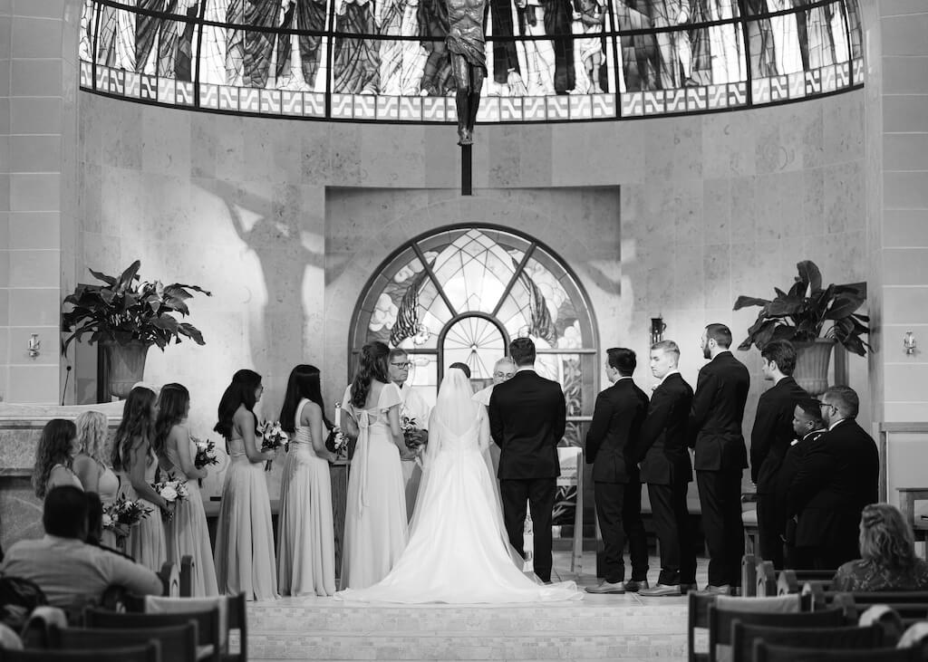 Bride and groom during their ceremony at St. Martin De Porres Catholic Church in Lake Charles, Louisiana, on Olivia and Landons Oak Crossing Wedding Day, photographed by Morgan Alysse Photography.