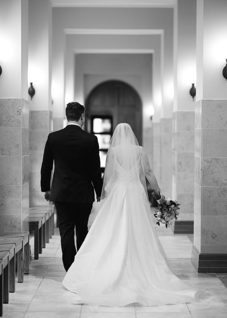 Bride and groom  during their ceremony at St. Martin De Porres Catholic Church in Lake Charles, Louisiana, on Olivia and Landons Oak Crossing Wedding Day, photographed by Morgan Alysse Photography.