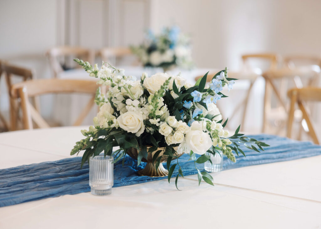 Tables with blue flowers at Olivia and Landon's Oak Crossing Wedding in Lake Charles, LA, photographed by Morgan Alysse Photography.