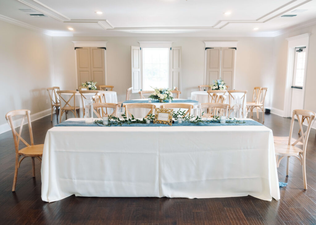 Tables with blue flowers at Olivia and Landon's Oak Crossing Wedding in Lake Charles, LA, photographed by Morgan Alysse Photography.