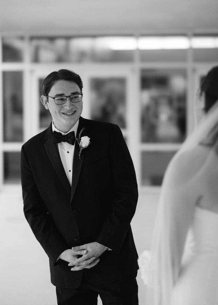 Groom reaction at Lauren and Colby's rainy day wedding at The Madison in Broussard, LA, photographed by Morgan Alysse Photography.