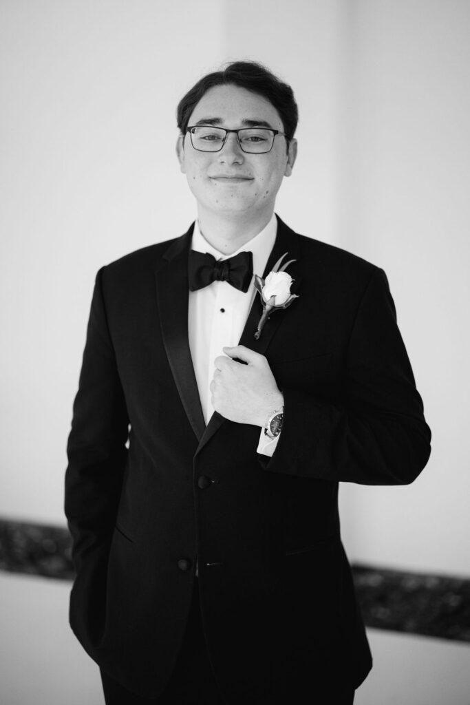 Black and white groom portrait at Lauren and Colby's rainy day wedding at The Madison in Broussard, LA, photographed by Morgan Alysse Photography.