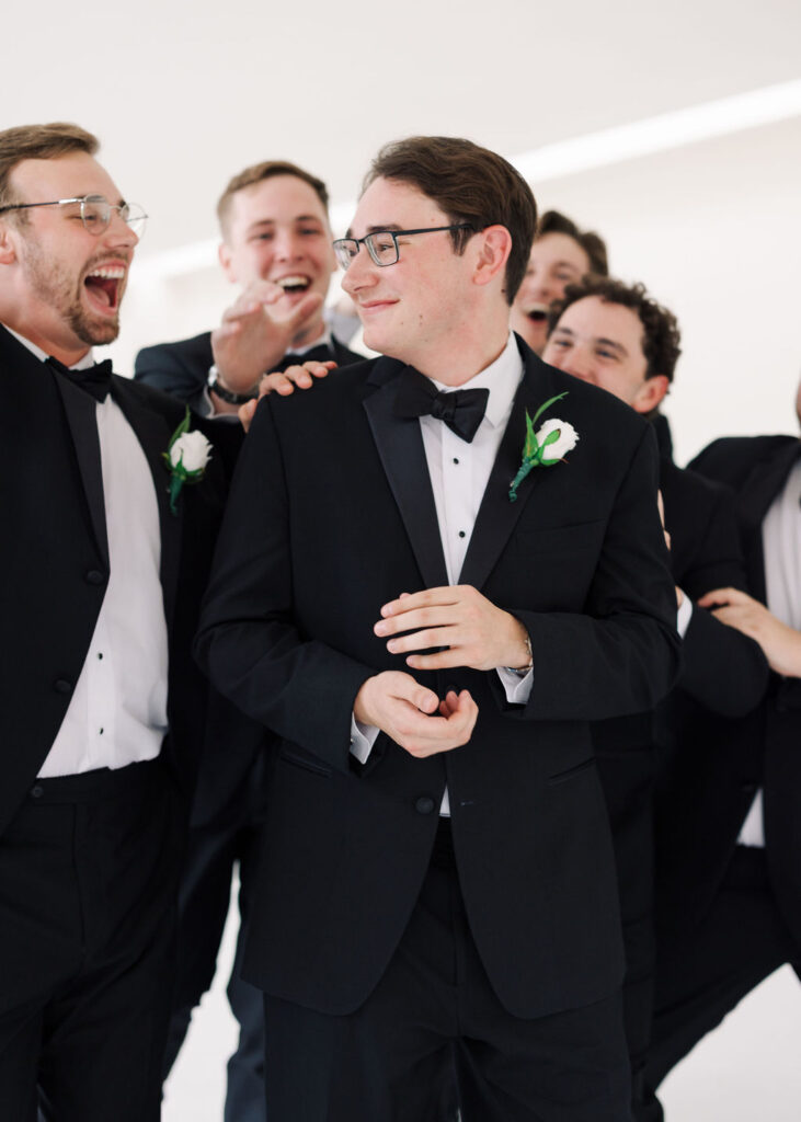 Groom candid photo at Lauren and Colby's rainy day wedding at The Madison in Broussard, LA, photographed by Morgan Alysse Photography.