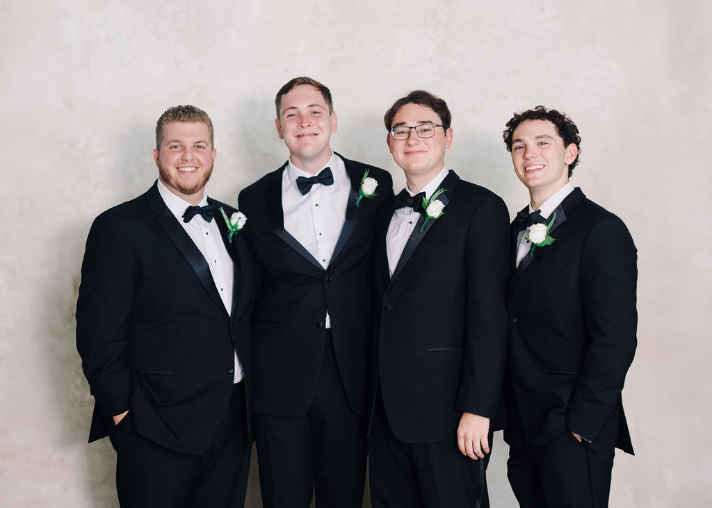 Groom and groomsmen portrait at Lauren and Colby's rainy day wedding at The Madison in Broussard, LA, photographed by Morgan Alysse Photography.