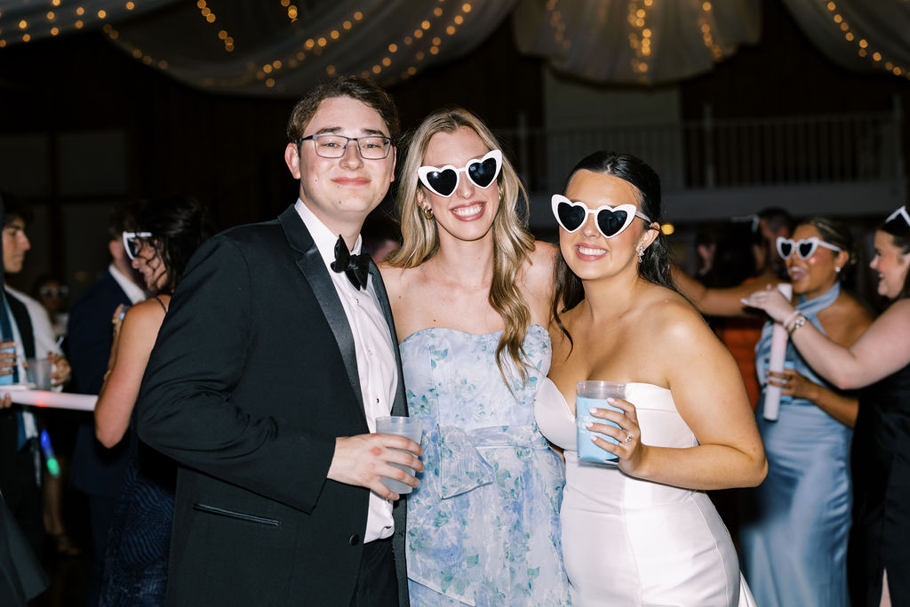 Bride and groom with a friend at Lauren and Colby's rainy day wedding at The Madison in Broussard, LA, photographed by Morgan Alysse Photography.