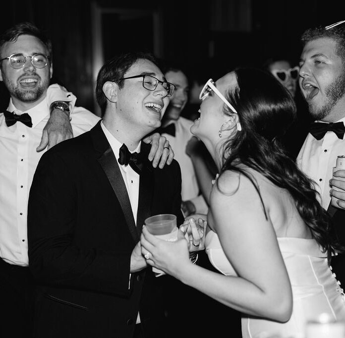 Bride and groom singing at Lauren and Colby's rainy day wedding at The Madison in Broussard, LA, photographed by Morgan Alysse Photography.