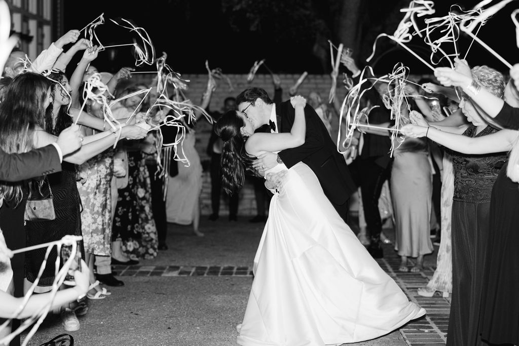 Black and white wedding exit photo at Lauren and Colby's rainy day wedding at The Madison in Broussard, LA, photographed by Morgan Alysse Photography.