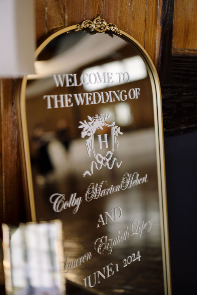 A welcome mirror sign at Lauren and Colby's rainy day wedding at The Madison in Broussard, LA, photographed by Morgan Alysse Photography.