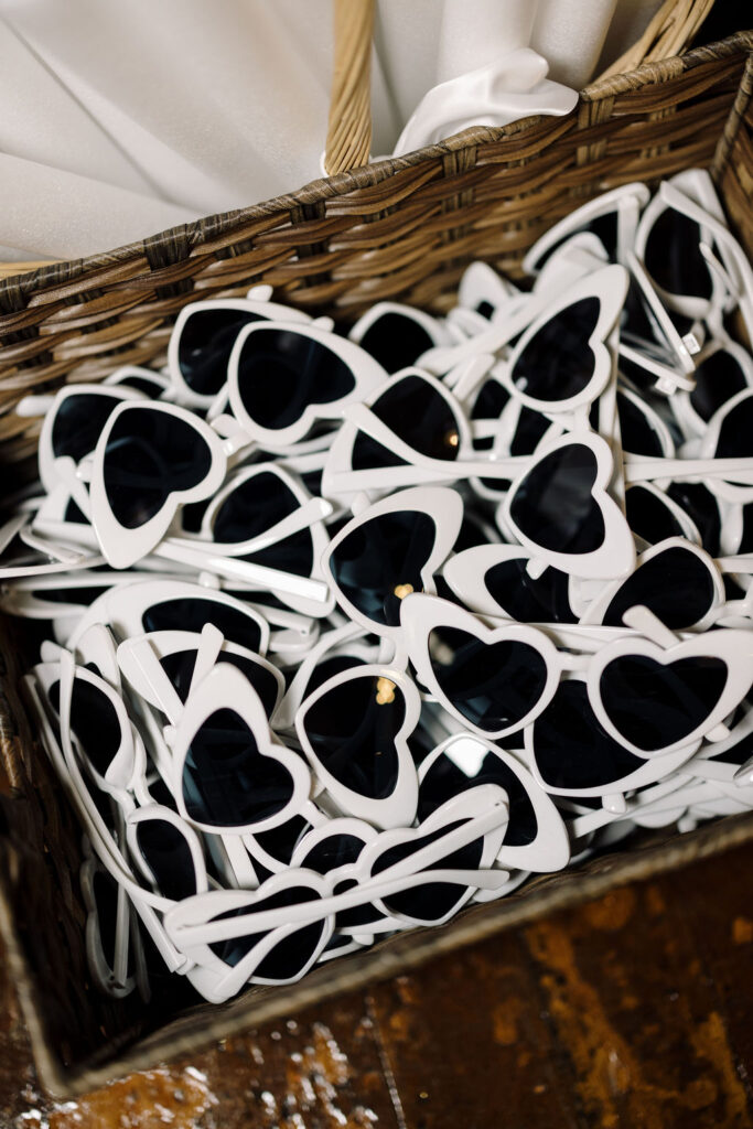 White heart-shaped sunglasses at Lauren and Colby's rainy day wedding at The Madison in Broussard, LA, photographed by Morgan Alysse Photography.