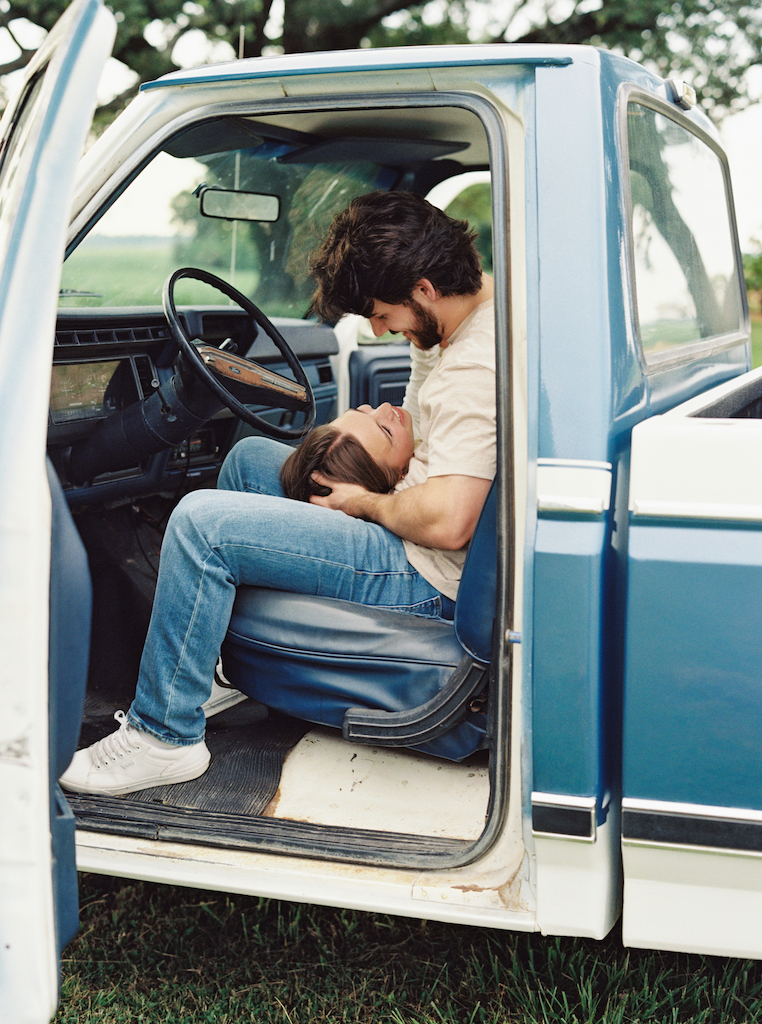 Romantic candid engagement session with a vintage truck near Lafayette, Louisiana, shot by Morgan Alysse Photography.