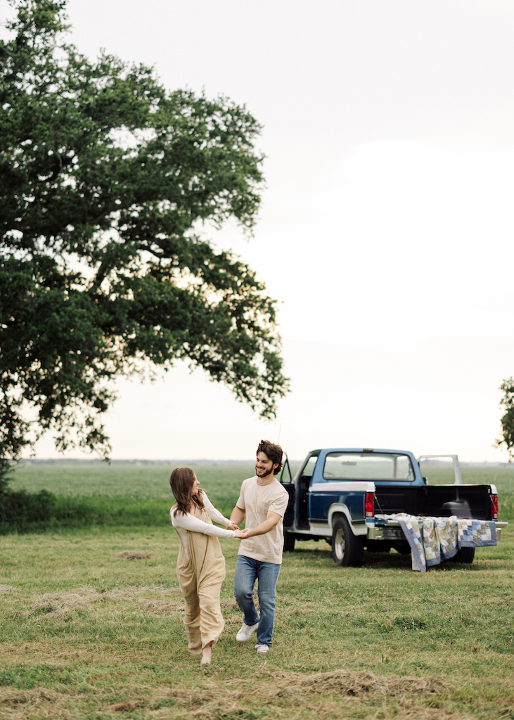 Romantic candid engagement session with a vintage truck near Lafayette, Louisiana, shot by Morgan Alysse Photography.