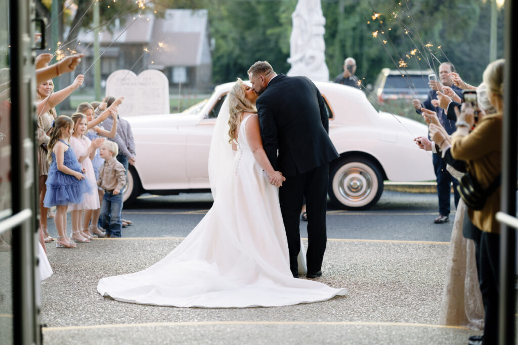 Bride and groom kissing at their wedding at St Landry Catholic Church captured by Morgan Alysse Photography