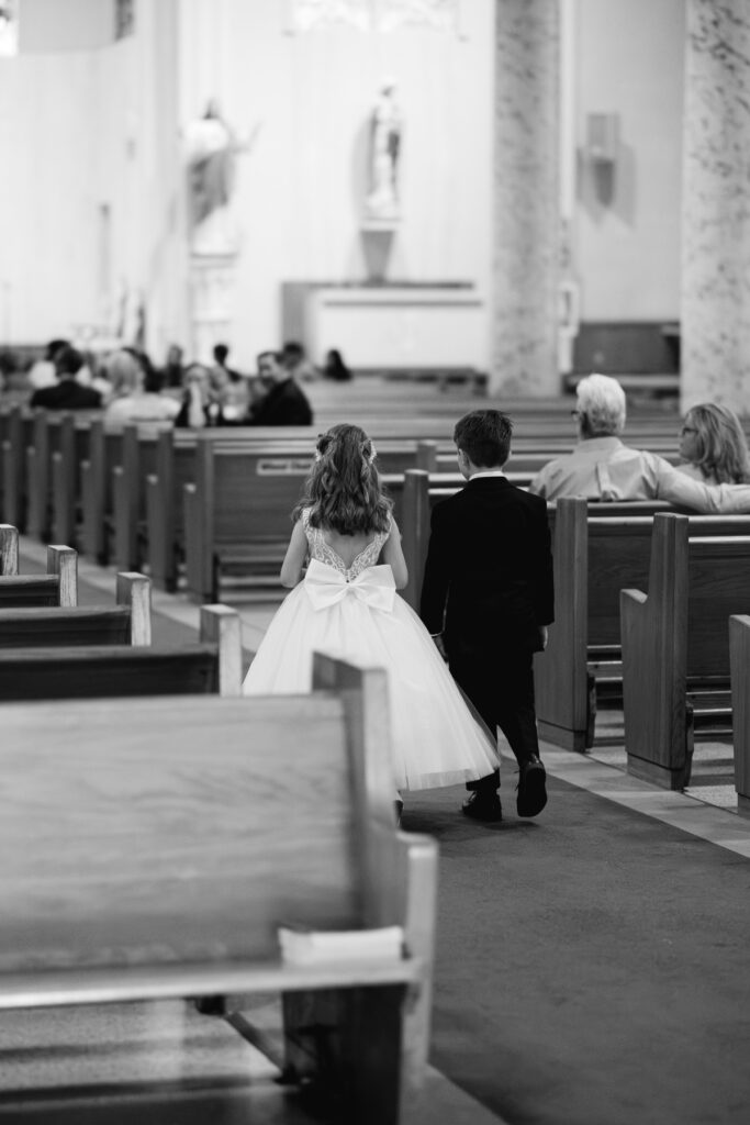 Flower girl and ring bearer at St Landry Catholic Church captured by Morgan Alysse Photography