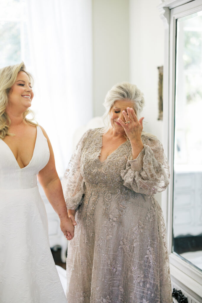 Bride getting dressed with her mother before her Opelousas wedding captured by Morgan Alysse Photography