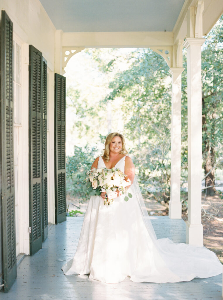 Bride posing with her white bouquet before her Opelousas wedding captured by Morgan Alysse Photography