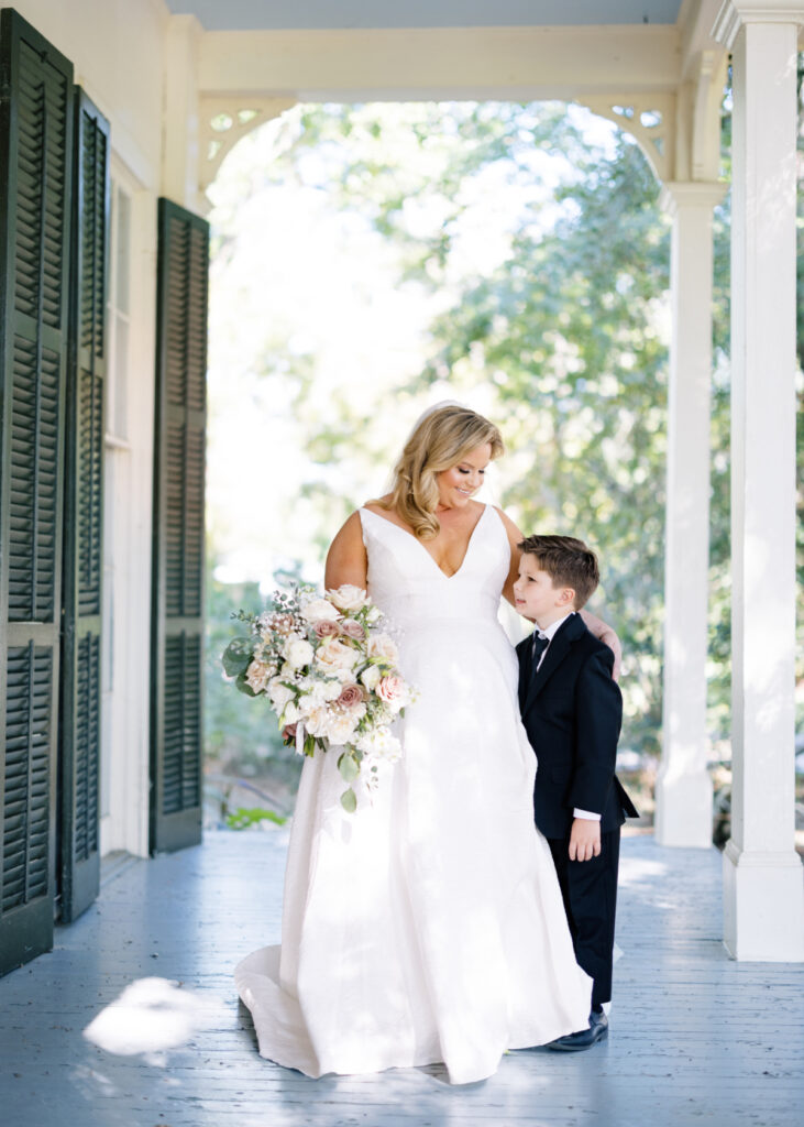 Bride posing with young son and bouquet before her Opelousas wedding captured by Morgan Alysse Photography