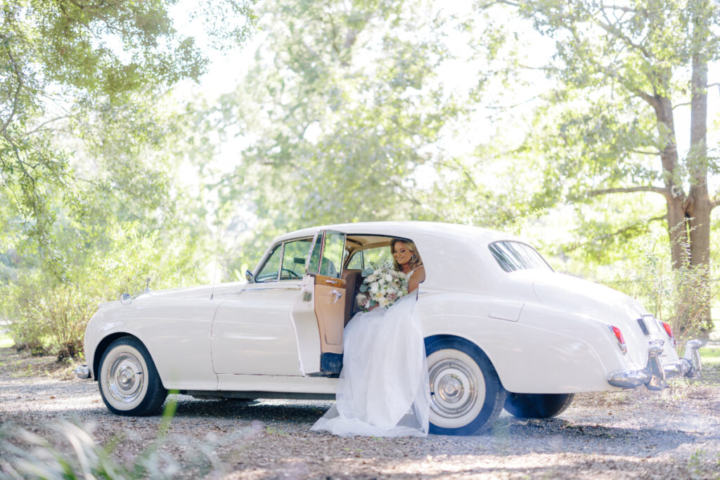 Bride getting in a vintage Rolls Royce limo before an Opelousas wedding captured by Morgan Alysse Photography