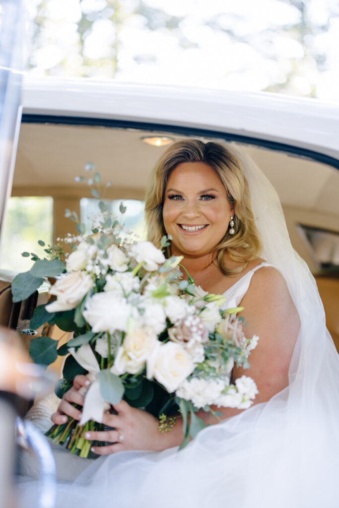 Bride getting in a vintage Rolls Royce limo before an Opelousas wedding captured by Morgan Alysse Photography