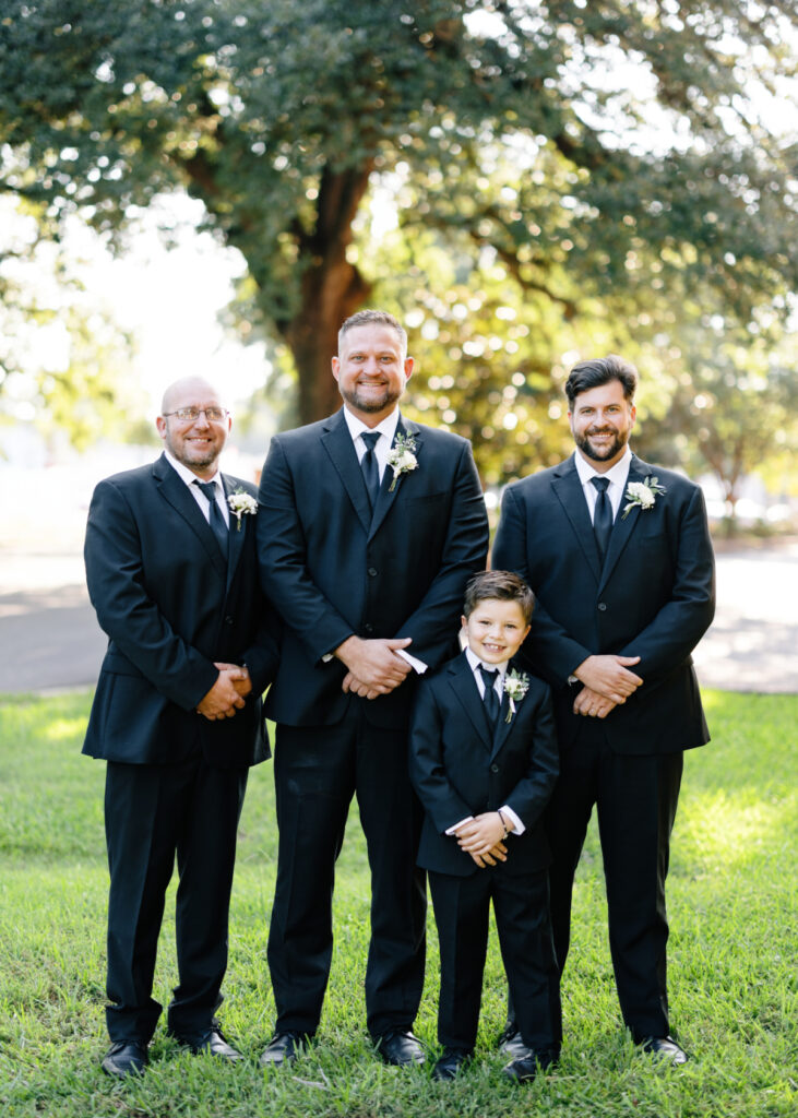 Groom and male family members all dressed in black tuxedos before his Opelousas wedding captured by Morgan Alysse Photography