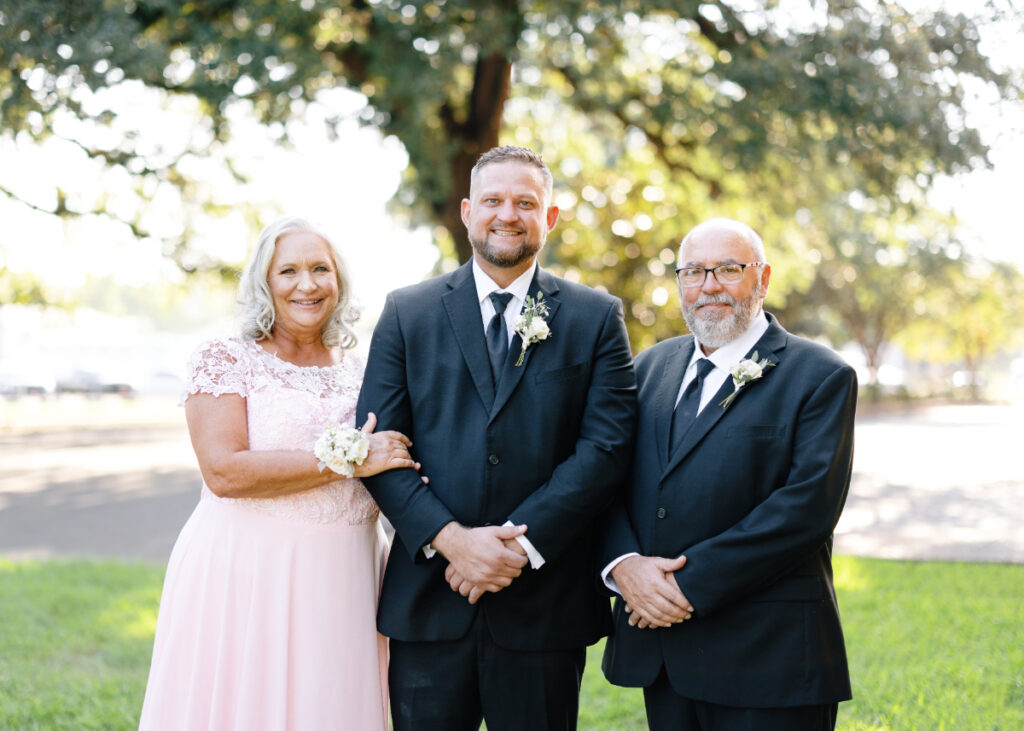 Groom posing with his parents before his Opelousas wedding captured by Morgan Alysse Photography