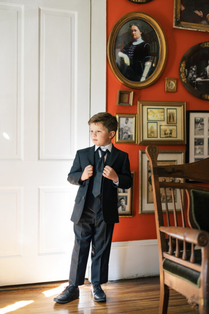 Bride's young son getting dressed before his mother's Opelousas wedding captured by Morgan Alysse Photography