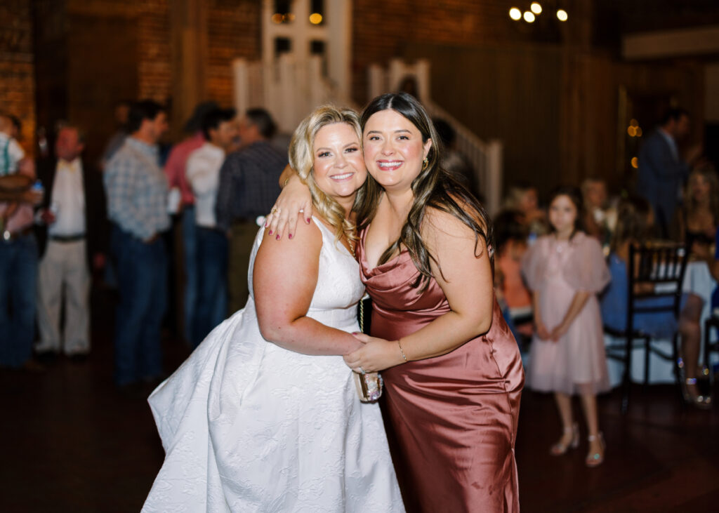 Bride dances with friend at her wedding reception at Wolff Banquets & Receptions captured by Morgan Alysse Photography