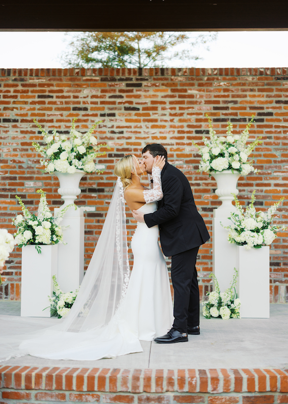 First kiss as newlyweds at Bayou Rum Distillery wedding