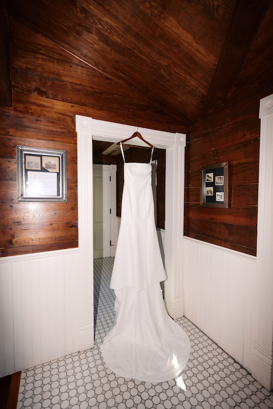 Wedding dress hanging in the Bayou Rum bridal suite before the ceremony