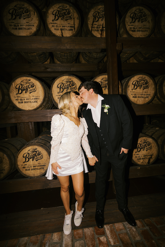 Groom lifting bride for a romantic portrait at Bayou Rum Distillery